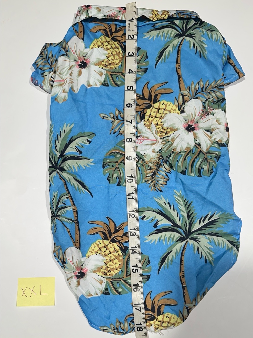 This is a blue dog shirt, snaps in the front, pineapple and palms. Size XXL